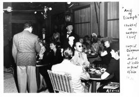 Arch of Triumph ; Chekhof as Gestapo Chief ; Ingrid Bergman is seated at table in front of him