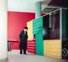 Le Corbusier vor dem Paravent in der Halle des Immeuble Molitor. Bemalte, mit Beton hintergosse…